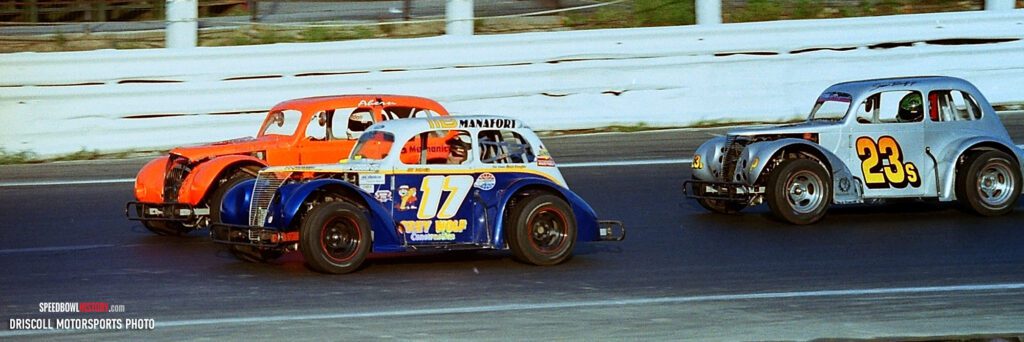 Black and white abstract pattern with concentric circles and wave shapes.