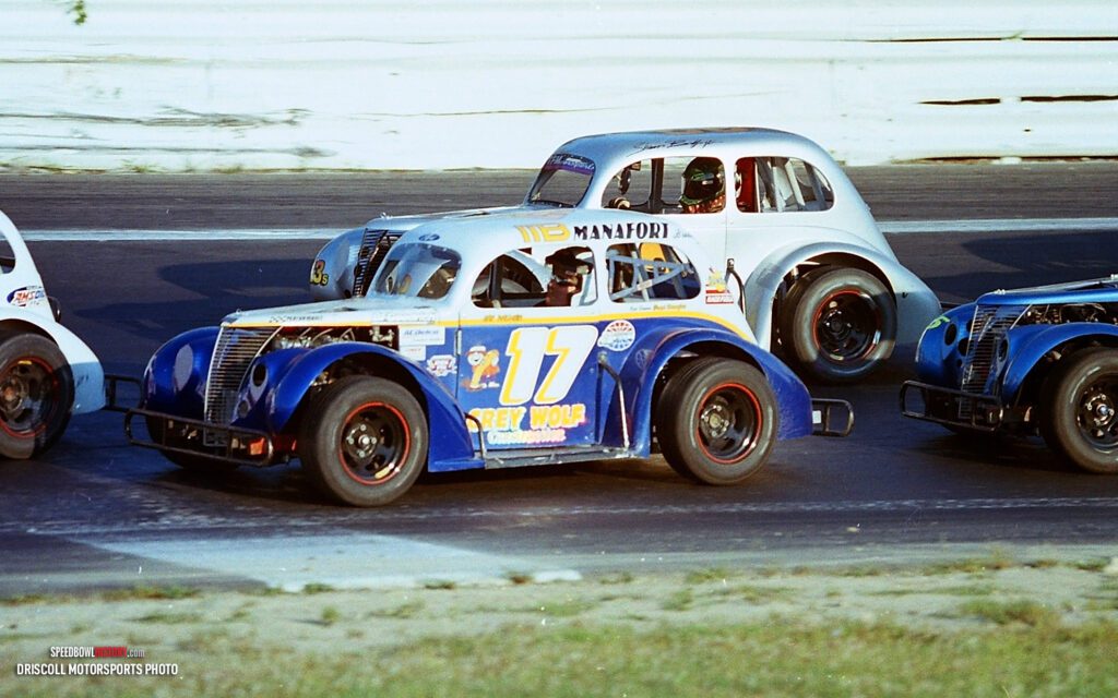 Black and white abstract pattern with concentric circles and wave shapes.