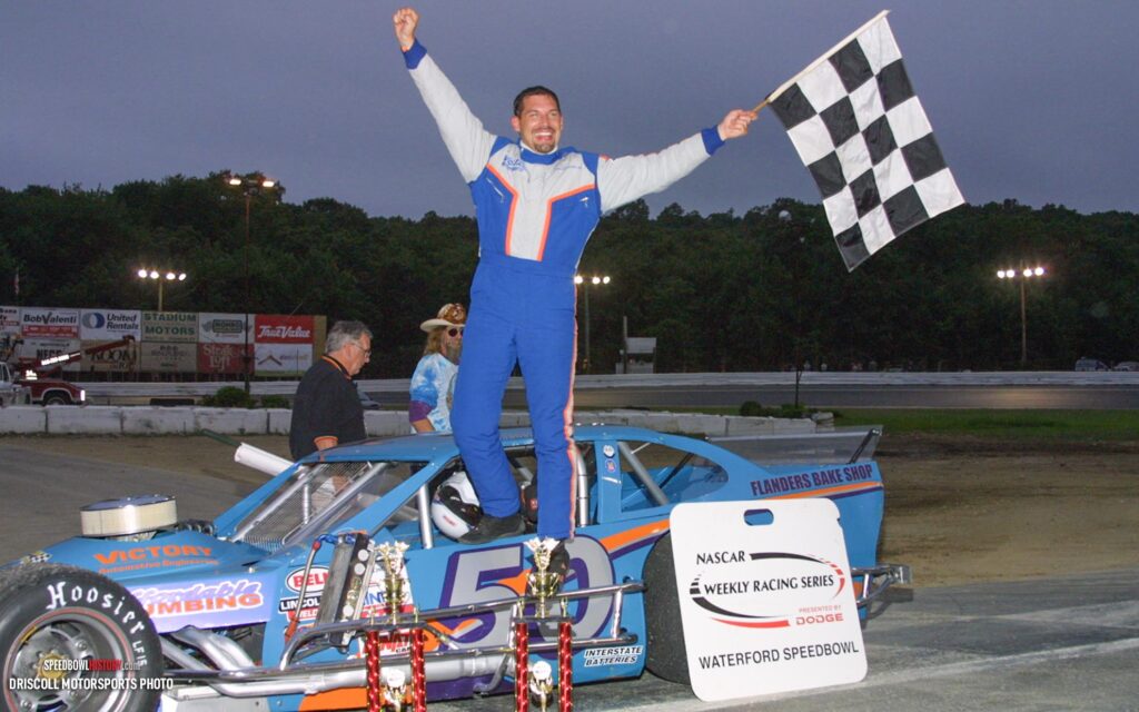 Black and white abstract pattern with concentric circles and wave shapes.