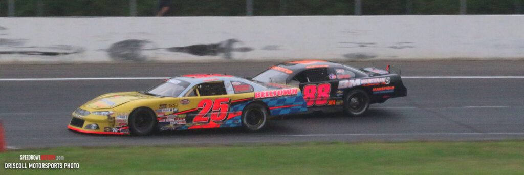 Black and white abstract pattern with concentric circles and wave shapes.