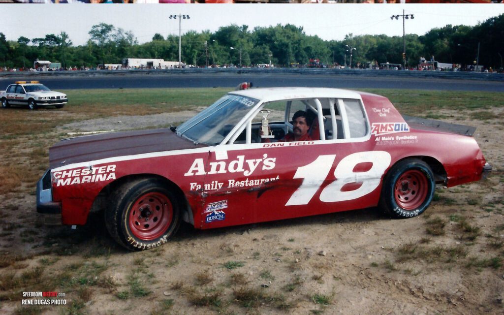 Black and white abstract pattern with concentric circles and wave shapes.