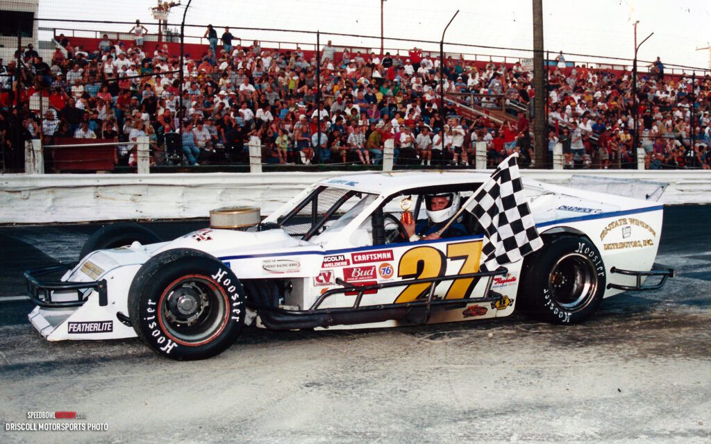 Black and white abstract pattern with concentric circles and wave shapes.