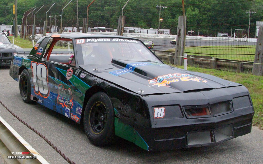 Black and white abstract pattern with concentric circles and wave shapes.