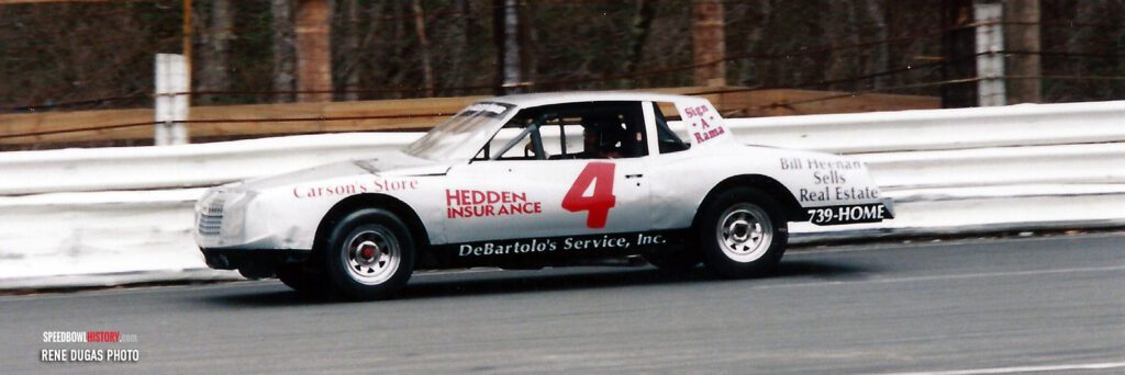 Black and white abstract pattern with concentric circles and wave shapes.