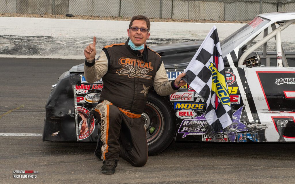 Black and white abstract pattern with concentric circles and wave shapes.