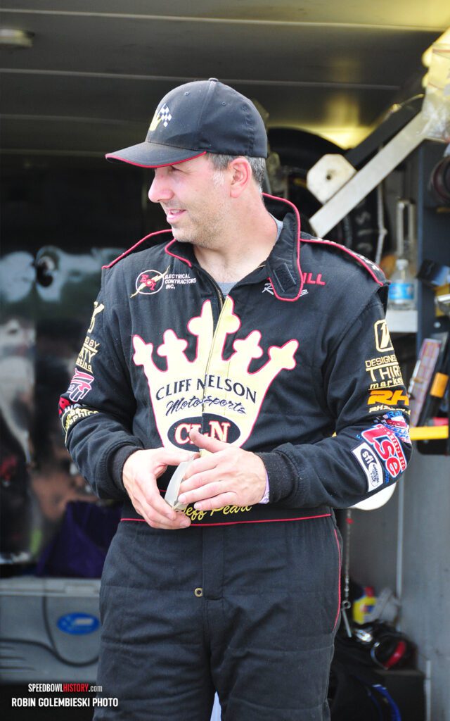 Black and white abstract pattern with concentric circles and wave shapes.