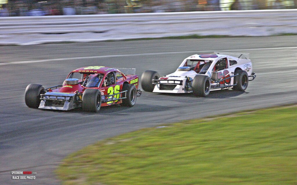 Black and white abstract pattern with concentric circles and wave shapes.