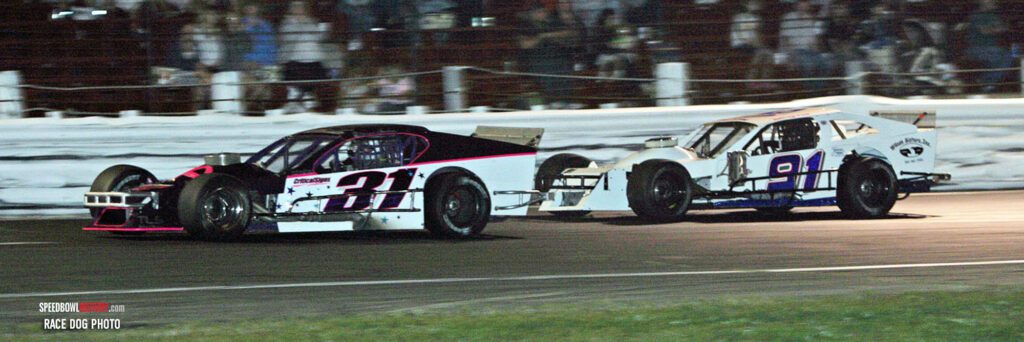 Black and white abstract pattern with concentric circles and wave shapes.