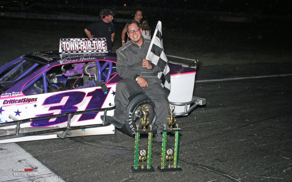 Black and white abstract pattern with concentric circles and wave shapes.