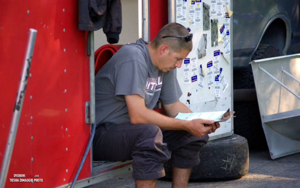 Black and white abstract pattern with concentric circles and wave shapes.