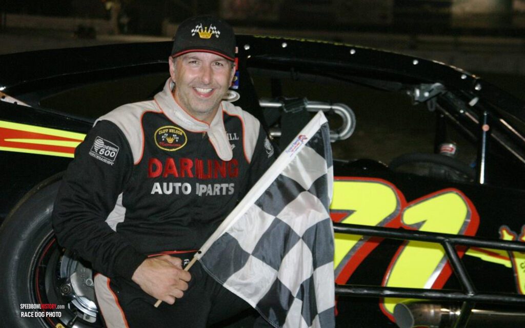 Black and white abstract pattern with concentric circles and wave shapes.