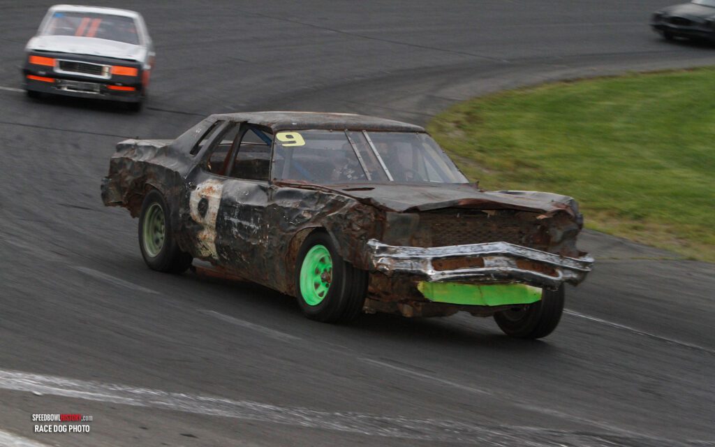 Black and white abstract pattern with concentric circles and wave shapes.