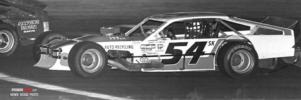 Black and white abstract pattern with concentric circles and wave shapes.