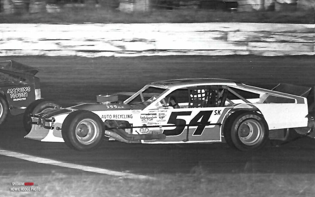 Black and white abstract pattern with concentric circles and wave shapes.