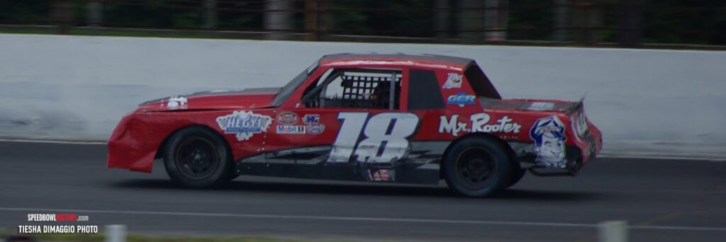 Black and white abstract pattern with concentric circles and wave shapes.