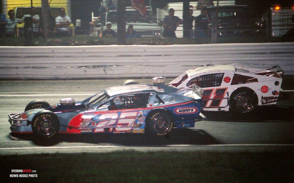 Black and white abstract pattern with concentric circles and wave shapes.