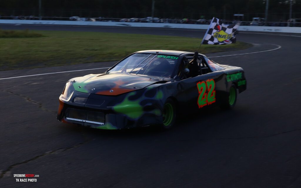 Black and white abstract pattern with concentric circles and wave shapes.