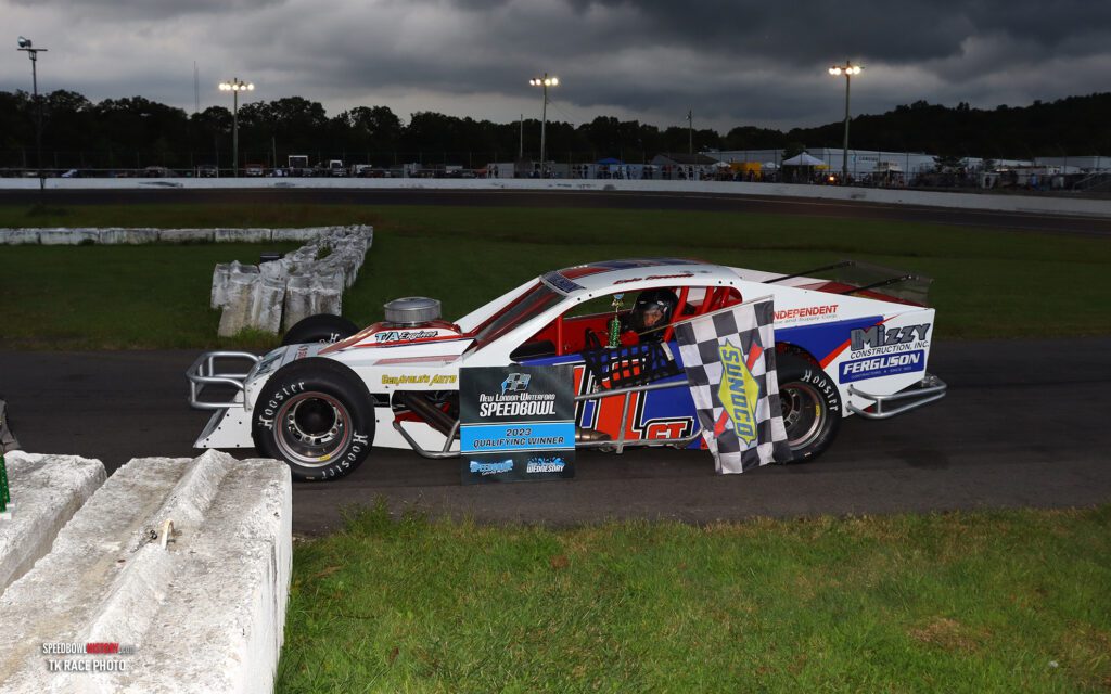 Black and white abstract pattern with concentric circles and wave shapes.