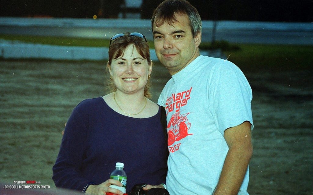 Black and white abstract pattern with concentric circles and wave shapes.