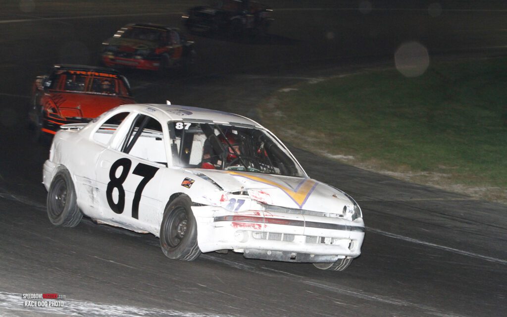 Black and white abstract pattern with concentric circles and wave shapes.