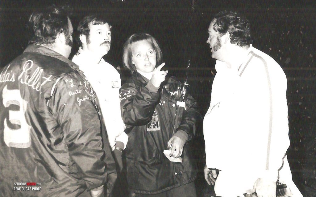 Black and white abstract pattern with concentric circles and wave shapes.