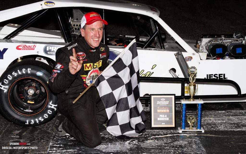 Black and white abstract pattern with concentric circles and wave shapes.