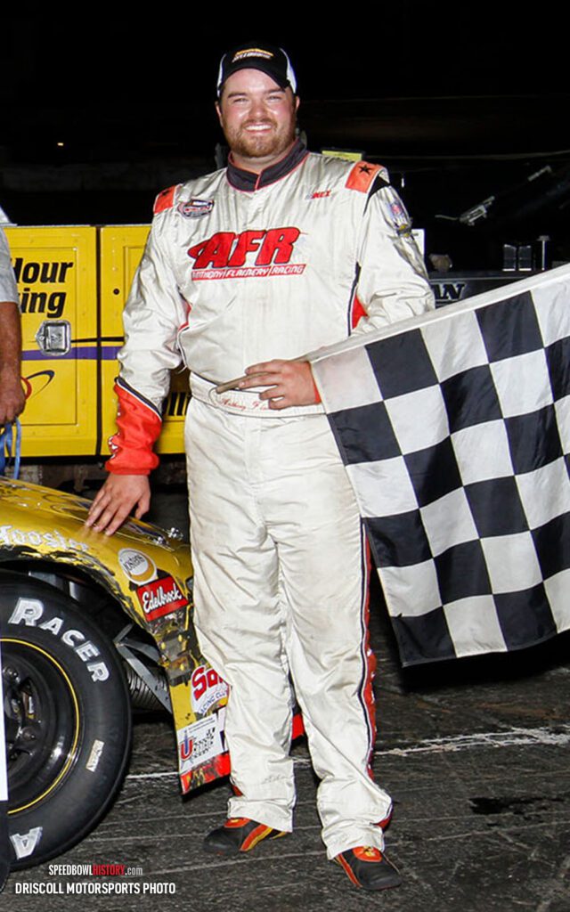 Black and white abstract pattern with concentric circles and wave shapes.