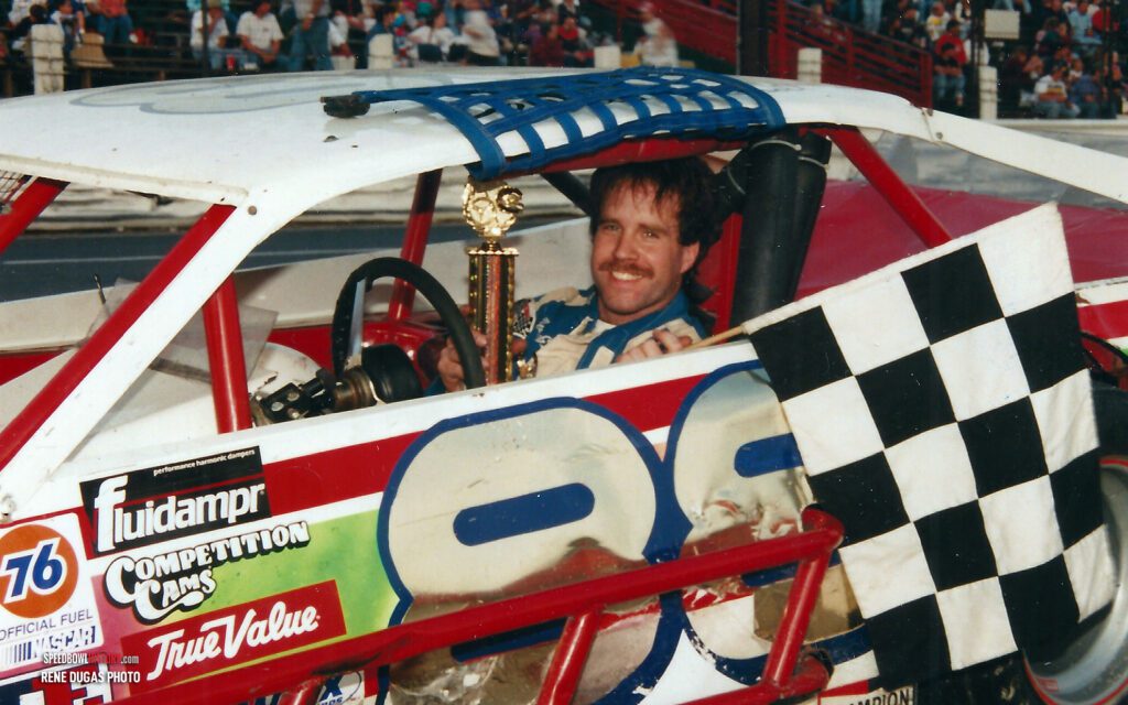 Black and white abstract pattern with concentric circles and wave shapes.