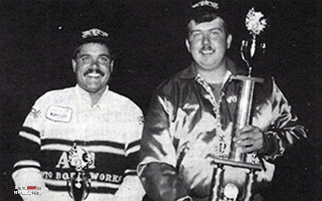 Black and white abstract pattern with concentric circles and wave shapes.