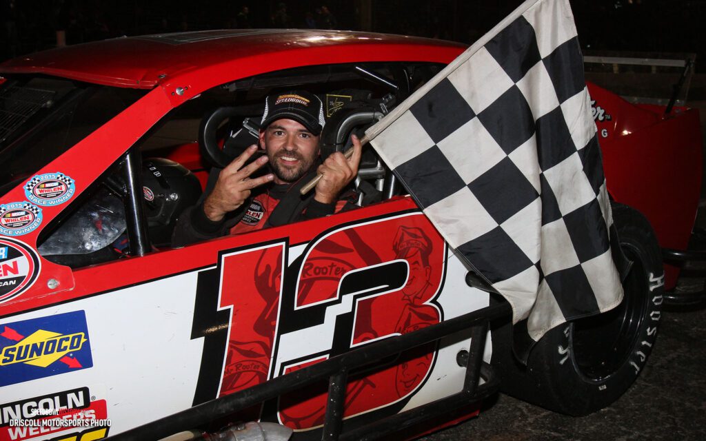 Black and white abstract pattern with concentric circles and wave shapes.