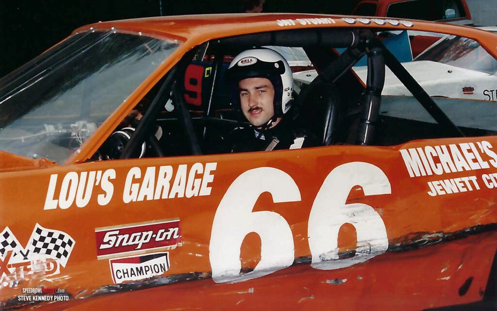 Black and white abstract pattern with concentric circles and wave shapes.