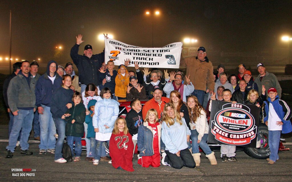 Black and white abstract pattern with concentric circles and wave shapes.