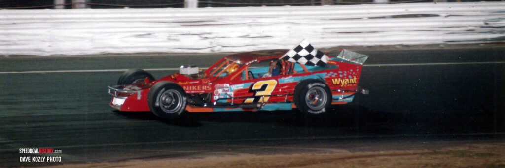 Black and white abstract pattern with concentric circles and wave shapes.