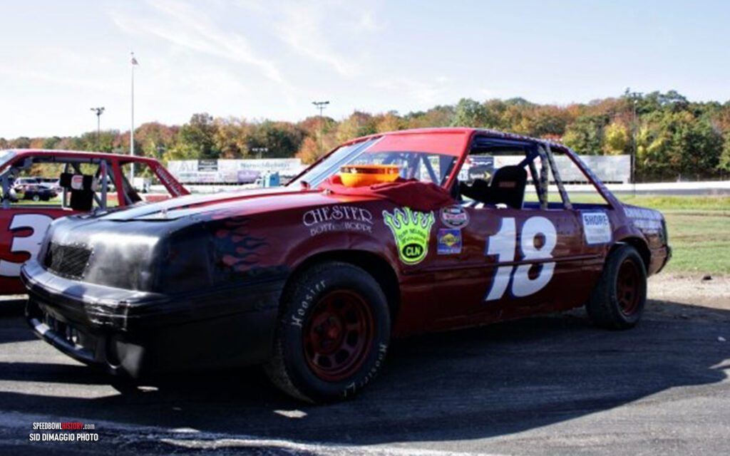 Black and white abstract pattern with concentric circles and wave shapes.