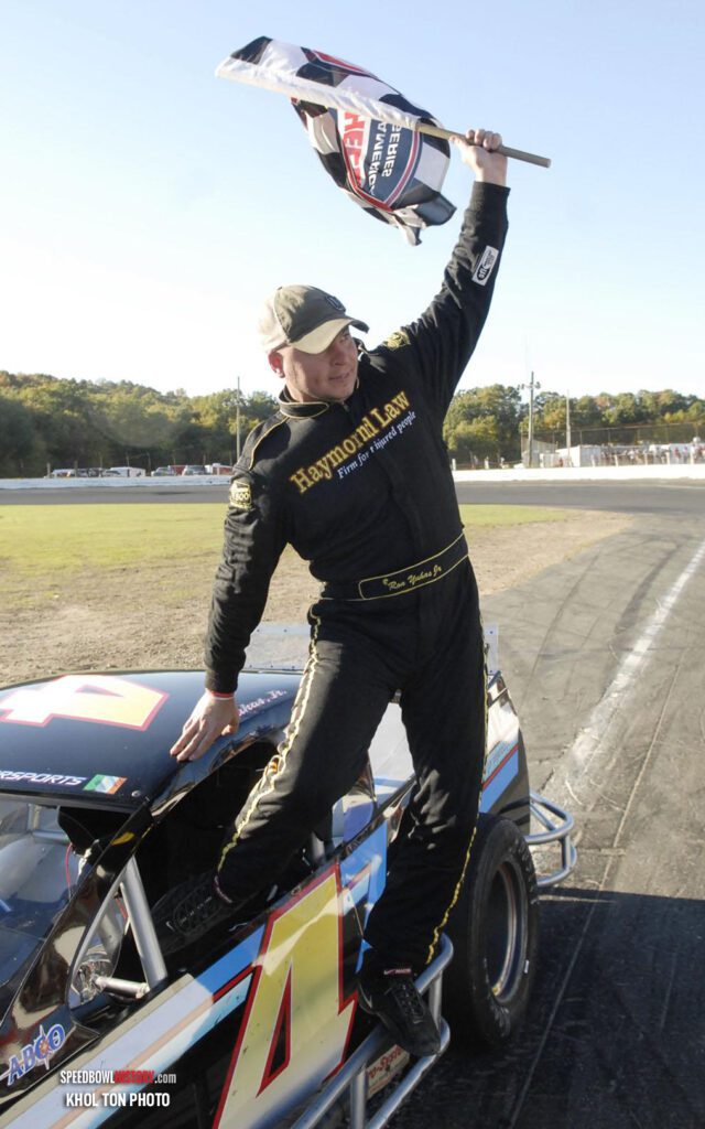 Black and white abstract pattern with concentric circles and wave shapes.