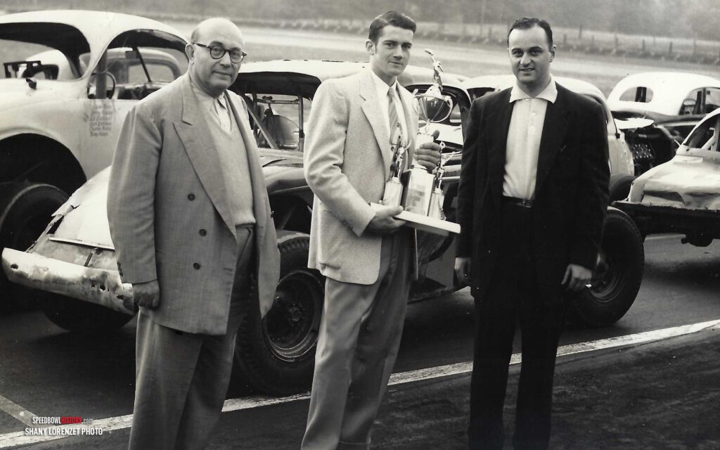 Black and white abstract pattern with concentric circles and wave shapes.