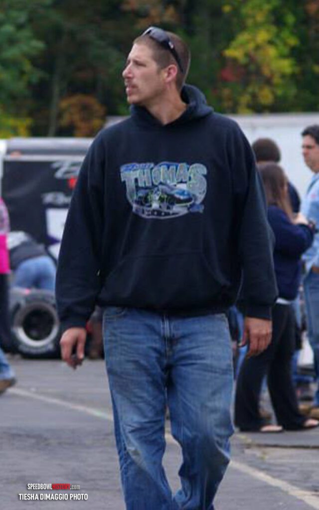 Black and white abstract pattern with concentric circles and wave shapes.