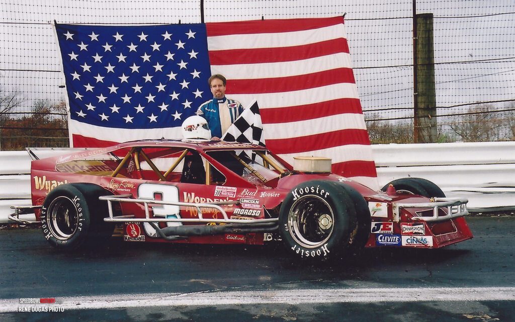 Black and white abstract pattern with concentric circles and wave shapes.