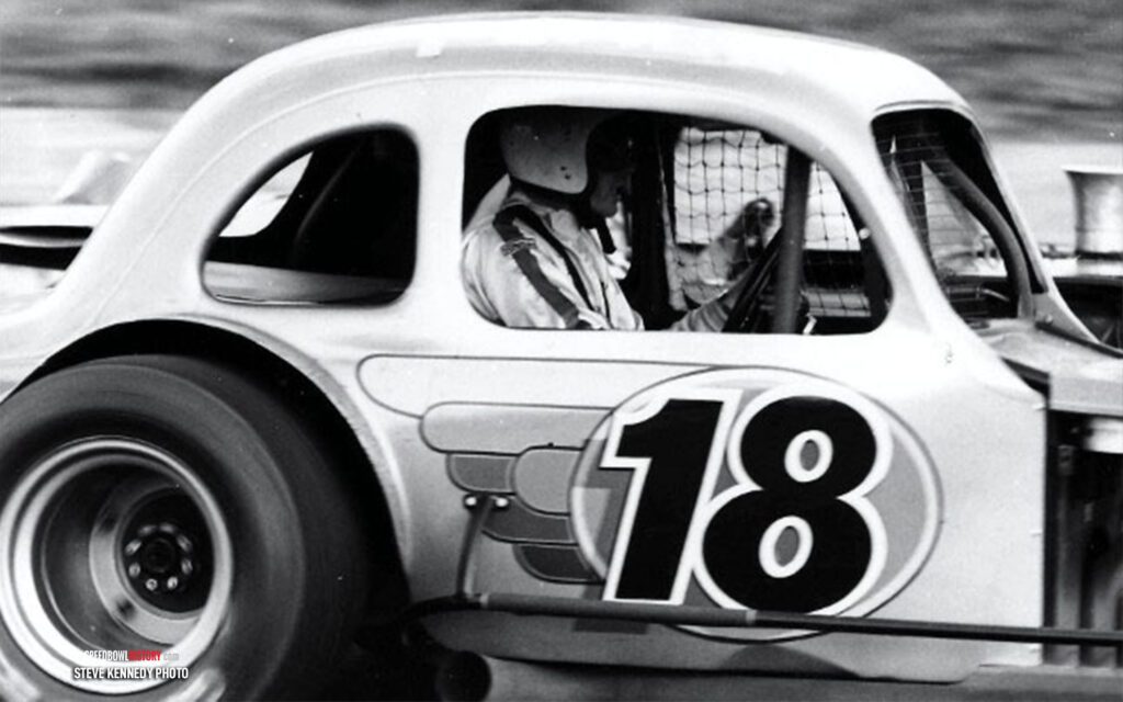 Black and white abstract pattern with concentric circles and wave shapes.