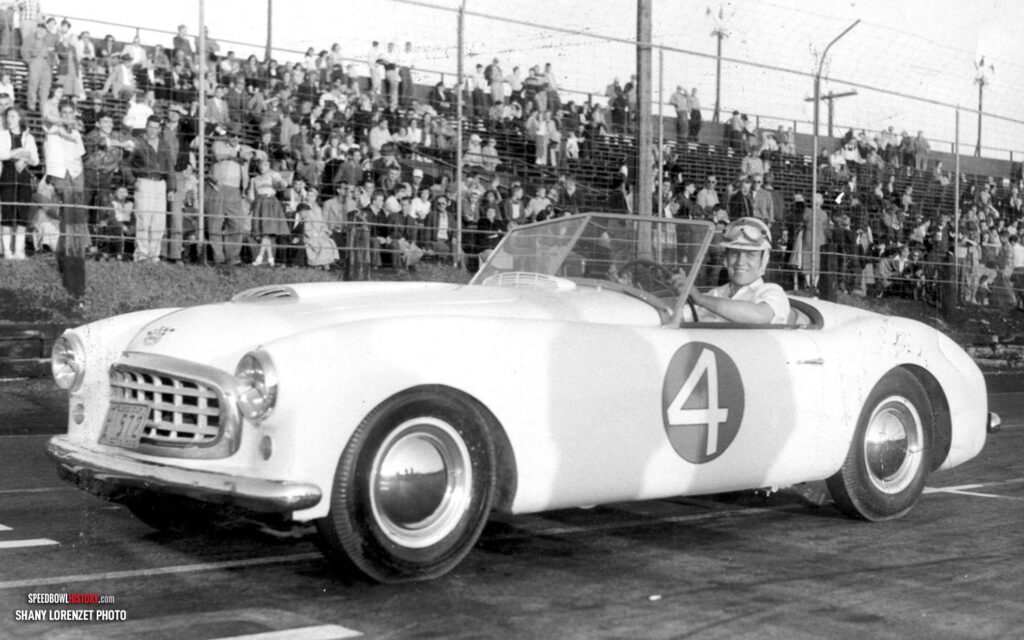 Black and white abstract pattern with concentric circles and wave shapes.