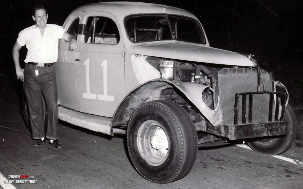 Black and white abstract pattern with concentric circles and wave shapes.