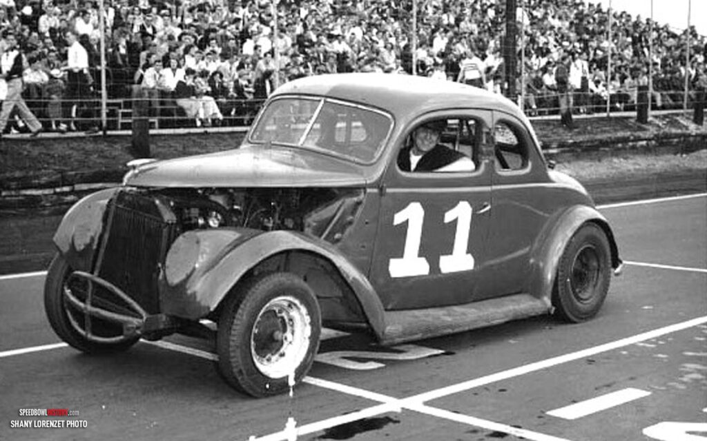 Black and white abstract pattern with concentric circles and wave shapes.