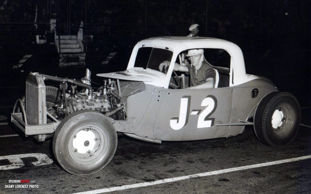 Black and white abstract pattern with concentric circles and wave shapes.