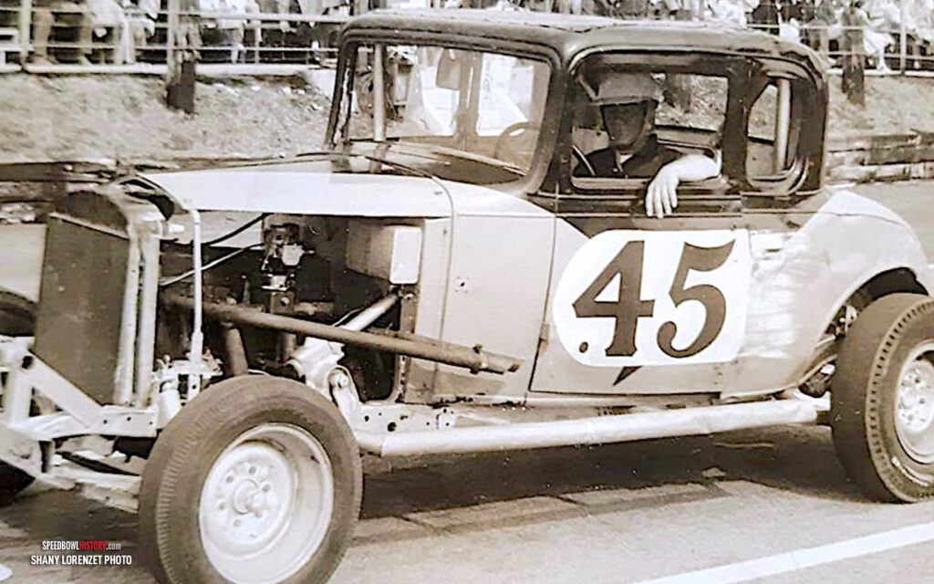 Black and white abstract pattern with concentric circles and wave shapes.