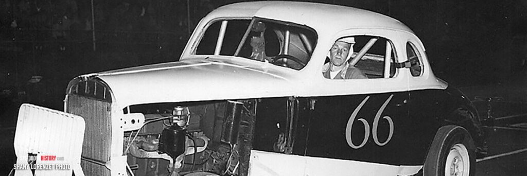 Black and white abstract pattern with concentric circles and wave shapes.