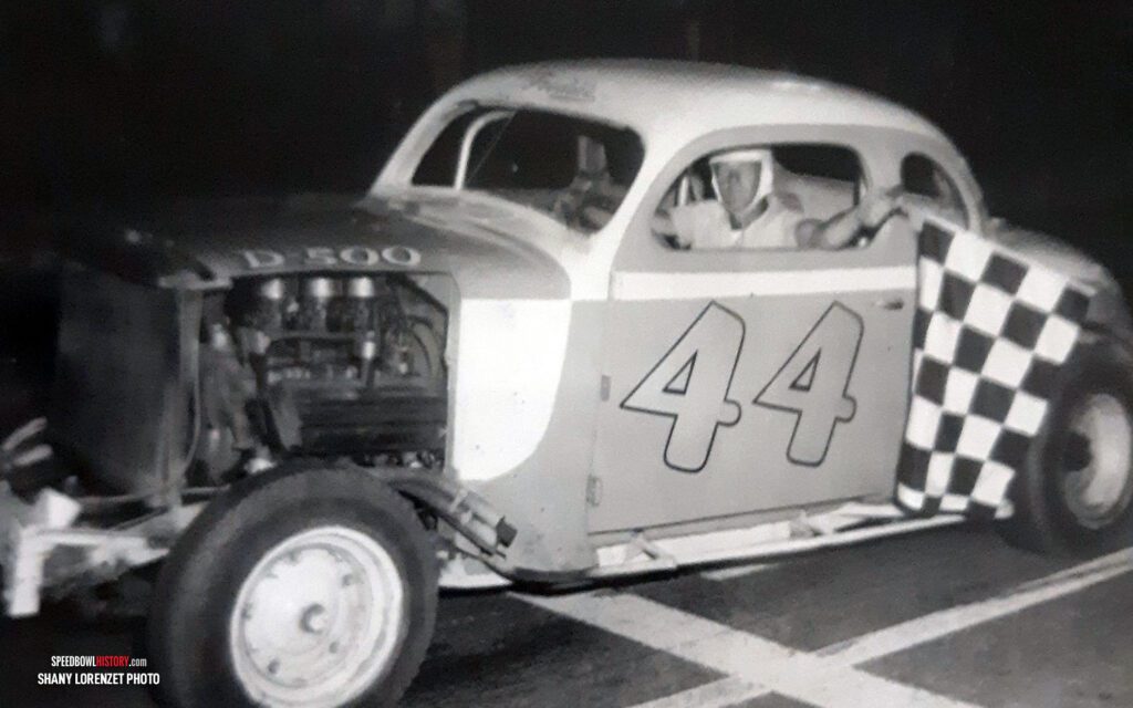 Black and white abstract pattern with concentric circles and wave shapes.