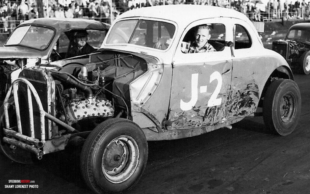 Black and white abstract pattern with concentric circles and wave shapes.