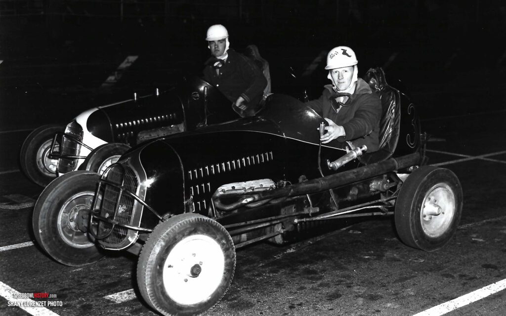 Black and white abstract pattern with concentric circles and wave shapes.