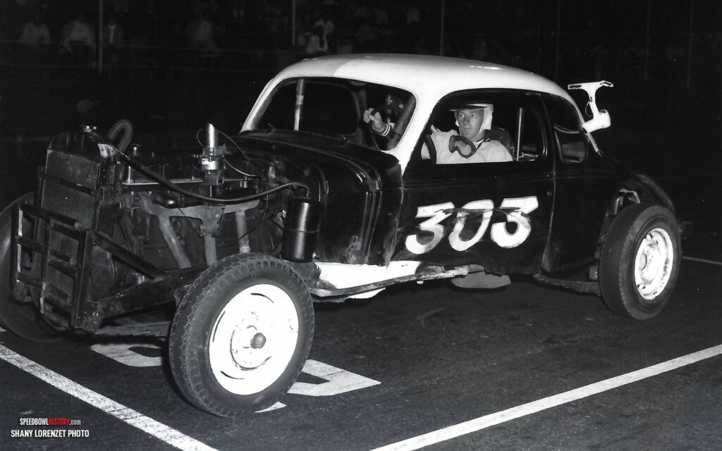 Black and white abstract pattern with concentric circles and wave shapes.