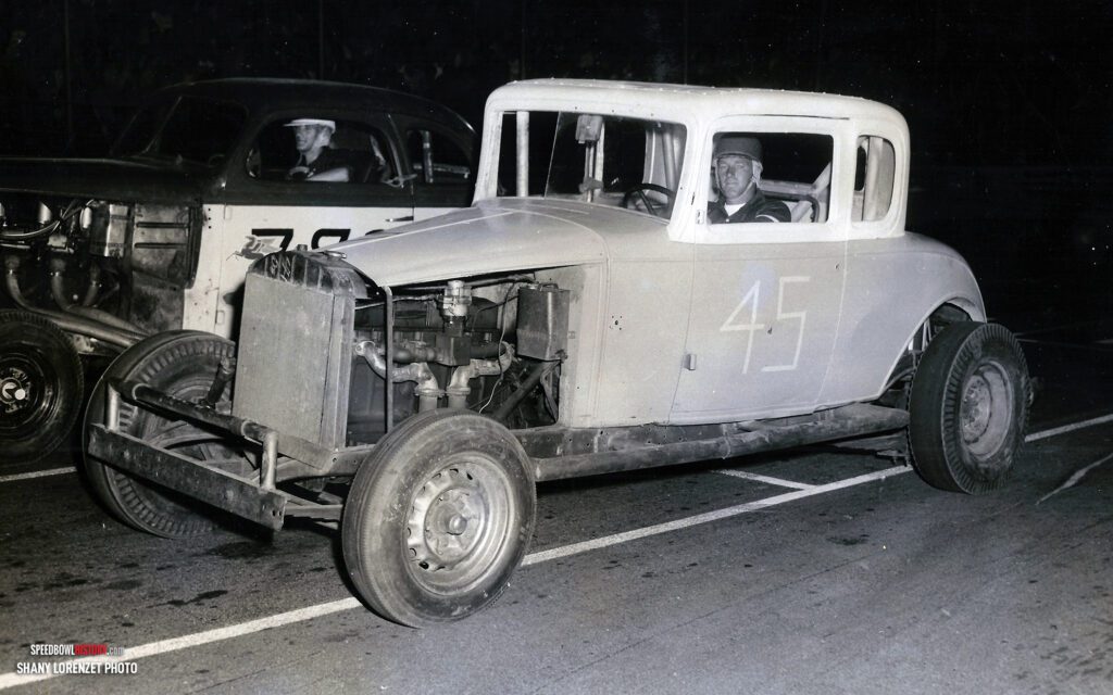 Black and white abstract pattern with concentric circles and wave shapes.